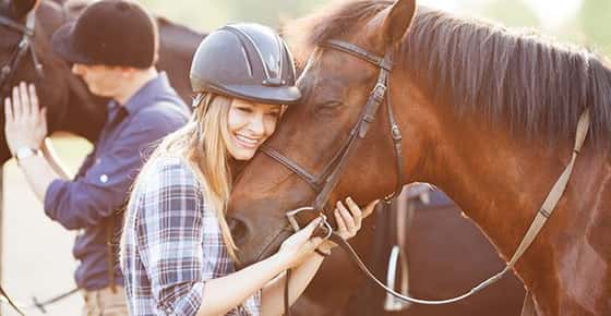 Image of woman hugging horse. 