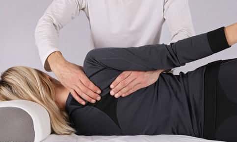 Woman receiving a back adjustment