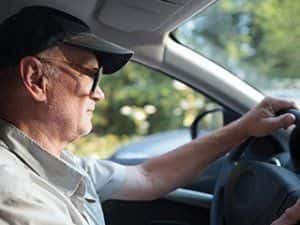 man with glasses driving
