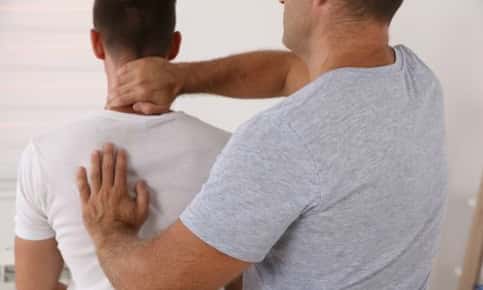 Man receiving an adjustment from a chiropractor