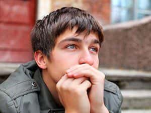 Image of a teenage boy staring into the distance.