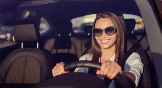 Woman is happy about protecting her eyes from the sun.