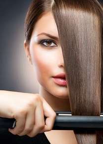 Image of a woman straightening her hair.