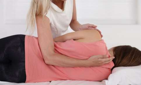 Woman receiving a chiropractic adjustment