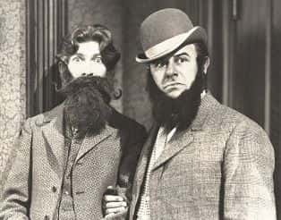 Old black and white image of men with beards.
