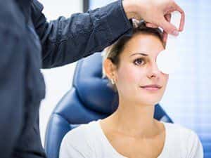 Image of a woman getting an eye exam.