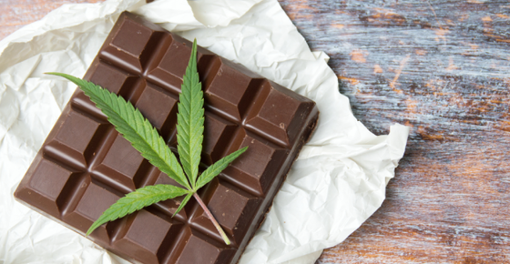 Image of a marijuana leaf over a bar of chocolate. 