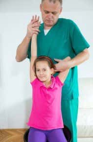 image of a chiropractor doing an adjustment on a young girl