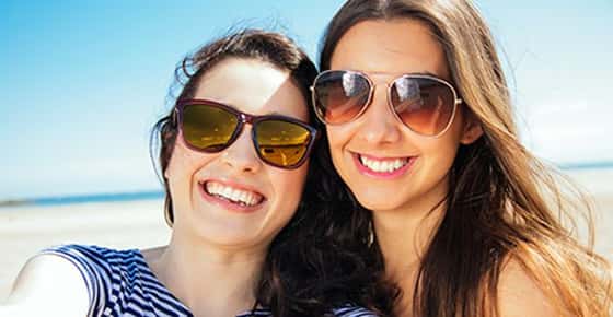 Image of two women wearing sunglasses.