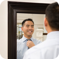 Image of man looking at himself in mirror. 