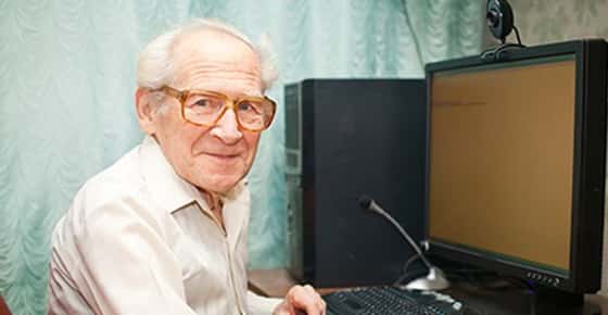 Image of old man at the computer. 