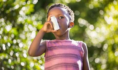 Child uses inhaler outdoors