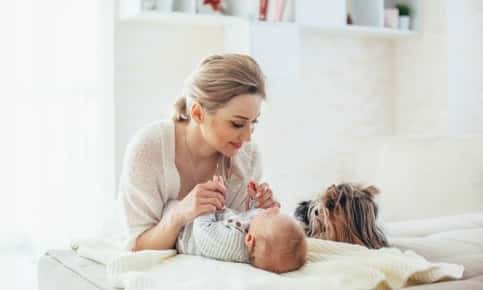 Newborn baby with mom and pet dog