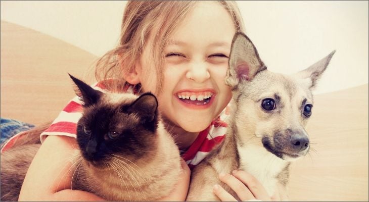 child with cat and dog