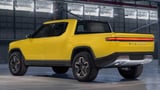 Rivian R1T electric truck yellow color rear view