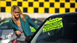 Young Woman Shopping for Cars