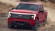 2023 Ford F-150 Lightning EV truck red paint off-road front view