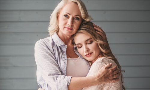 Mother and daughter hugging