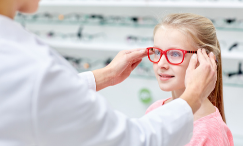 Little girl trying on glasses