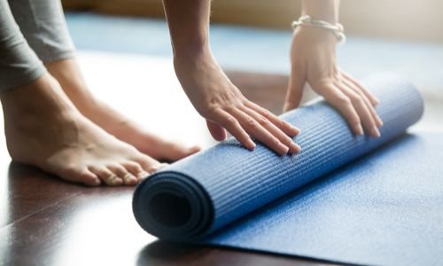 Woman with yoga mat 