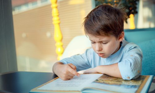 Little boy struggling to read