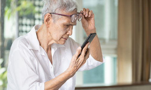 Older woman struggling to see