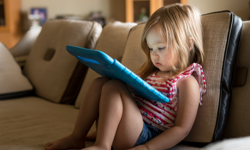 Little girl playing with a tablet 