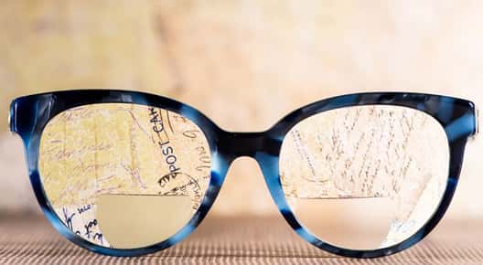 Image of glasses resting on a newspaper.