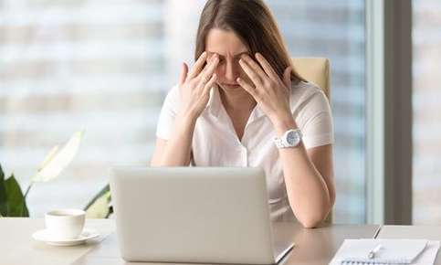 A woman experiencing eyestrain