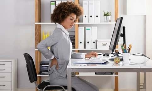 Woman sitting in office chair with bad posture