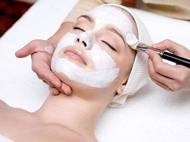 Image of a woman receiving a facial mask.