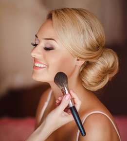 Image of a woman getting her makeup done.