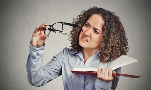 Woman having trouble seeing with glasses