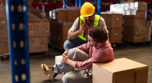 Man helps employee with work injury.