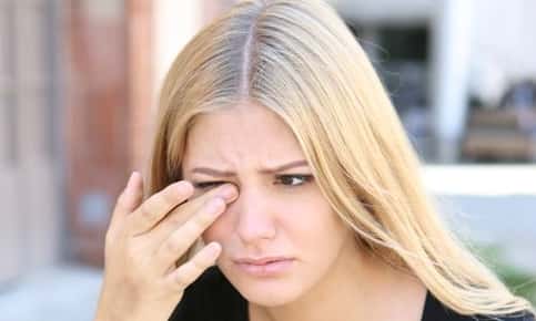 Woman rubbing her eye