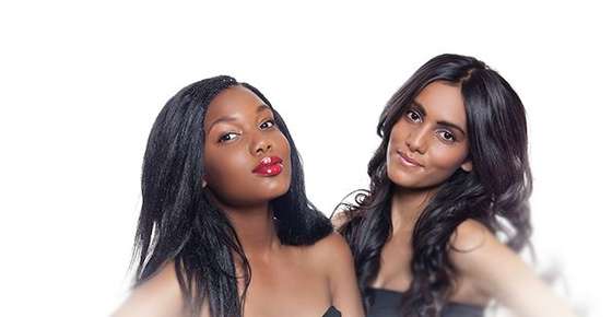 Image of two women with long, loosely curled hair.