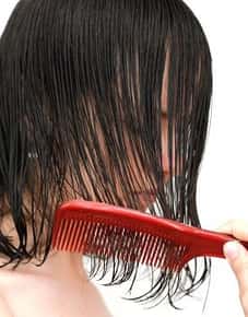 Image of a comb brushing through wet hair.