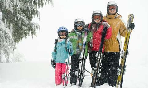 family in goggles skiing 