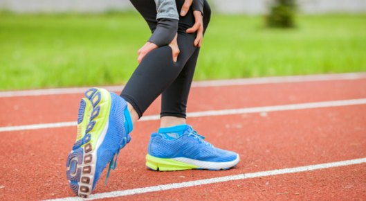 Woman grabbing her calf in pain