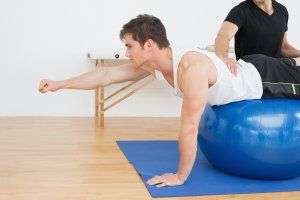 image of chiropractor working with a patient on an exercise ball