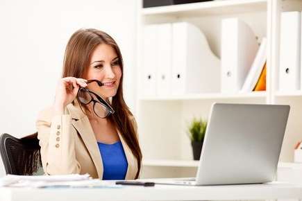 Image of woman looking at laptop screen.