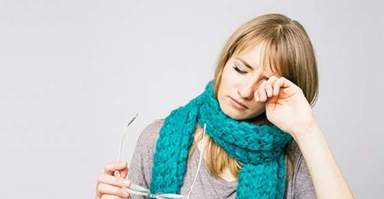 Image of woman rubbing her eyes.