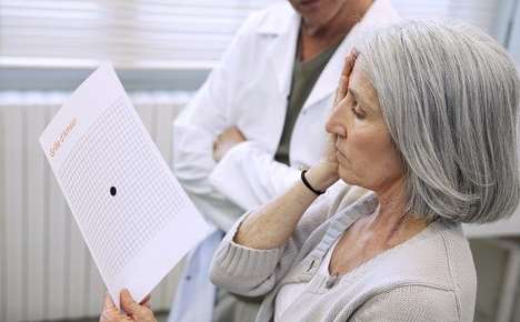 woman covering right eye while looking at object