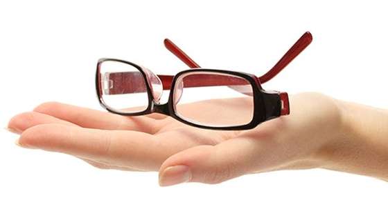 Image of a hand holding glasses. 