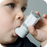 image of young boy using an inhaler
