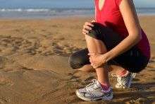 image of a woman gripping her shin