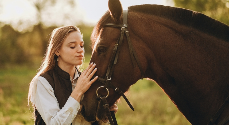 Woman bonds with her horse.