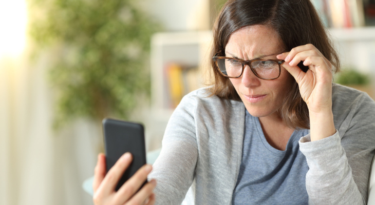 Woman with presbyopia tries to read phone