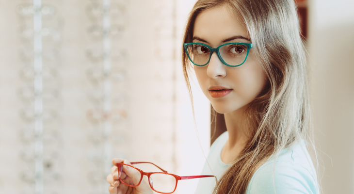 Pretty girl tries on glasses.