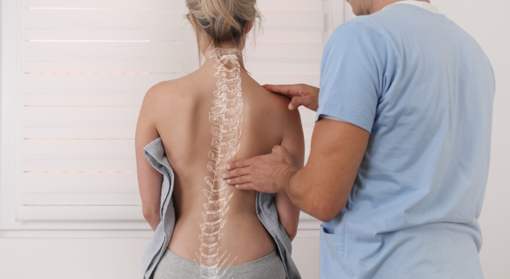 Woman with scoliosis gets treatment from her chiropractor
